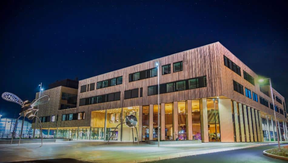 Åsane Kulturhus facade with lights coming from inside against