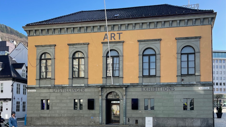 Kunsthall 3,14', a historic building with a yellow facade and arched windows. The word